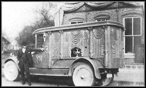 L.O. Wertenberger& his first motorized hearse in 1925  in front of Laketon Harware Store